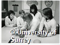Photographs of students in the Department of Nursing Studies at the University of Surrey examining a skull and brain