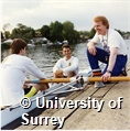 Photograph of members of the University of Surrey Boat Club rowing on a river