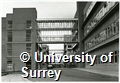 Photograph of the exterior of Senate House and walkways crossing the road at the University of Surrey Stag Hill Campus
