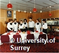 Photograph of students in the Department of Management Studies for the Hotel and Tourism Industries preparing to cook and serve lunch in the teaching restaurant at the University of Surrey
