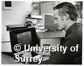 Photograph of Glyn Davies, a member of staff in the University of Surrey Library on Stag Hill Campus, working on a computer
